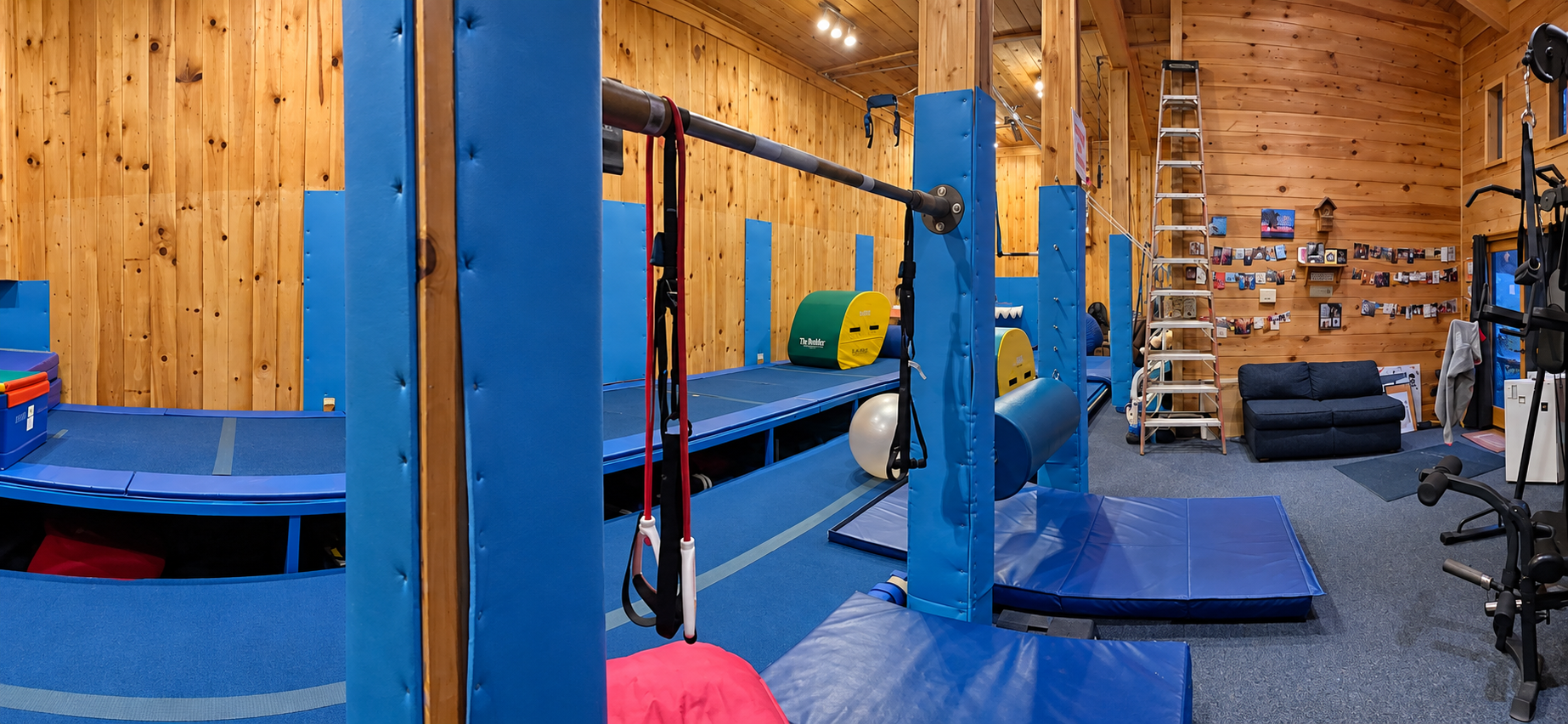 Padded bars and blue training equipment in the indoor gym